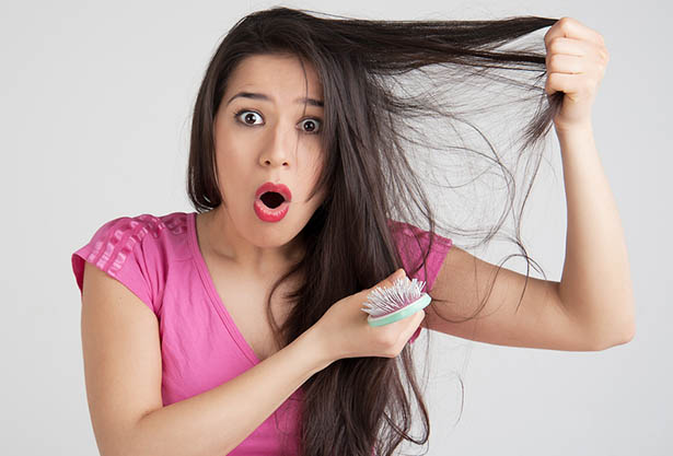 Young woman shocked state of hair on the head