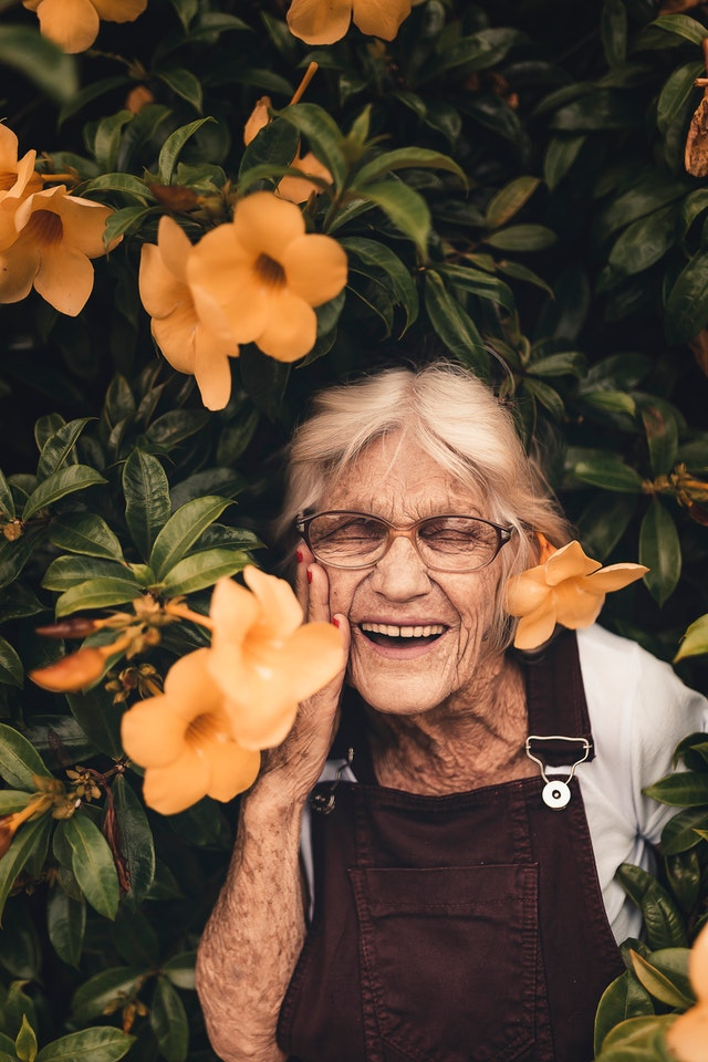 Happy old woman depicting Health benefits of Lemon.